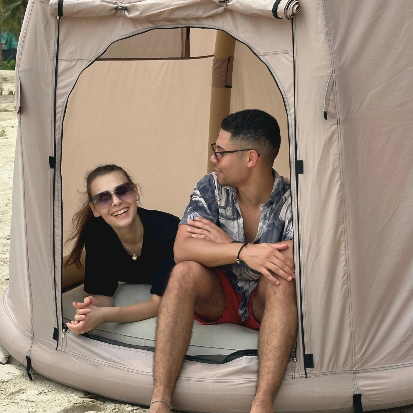 Couple enjoying Halrove inflatable camping tent on the beach, providing portable and comfortable shelter.