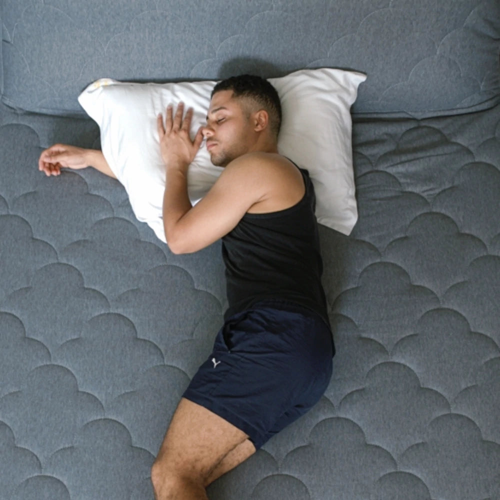 A man peacefully sleeping on the Halrove Queen Size Inflatable Mattress, showcasing its comfort and support.