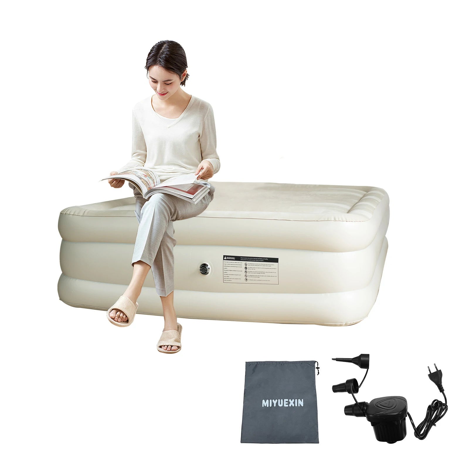 Woman relaxing on a queen size inflatable air mattress, perfect for home and camping use.