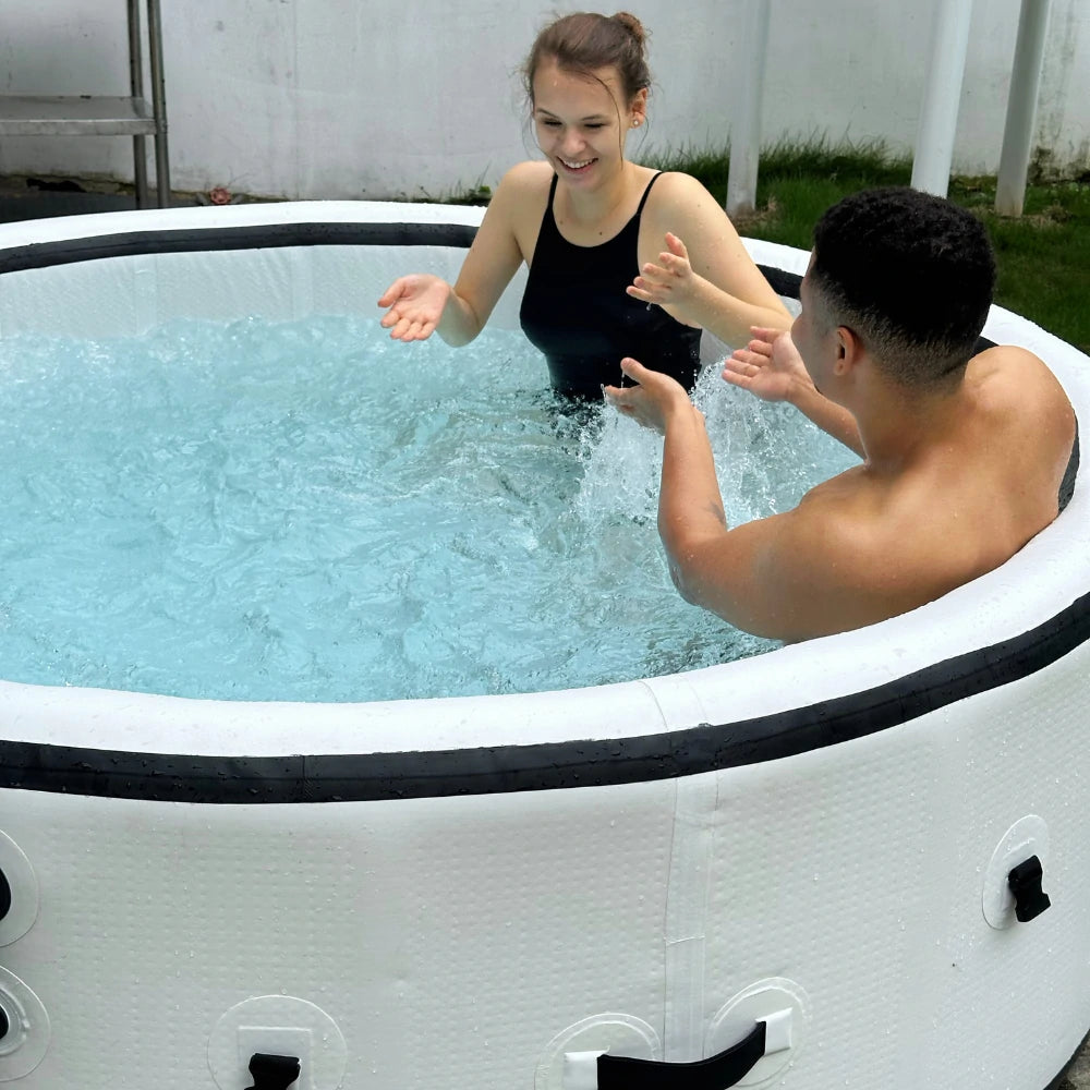 Two people having fun in a blow-up hot tub with powerful jets